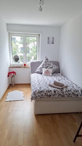 a bedroom with a bed and a window at Messe-Badische SBB- grosse Wohnung in Basel