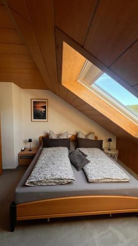 a large bed in a room with a window at Haus Bergblick in Olsberg