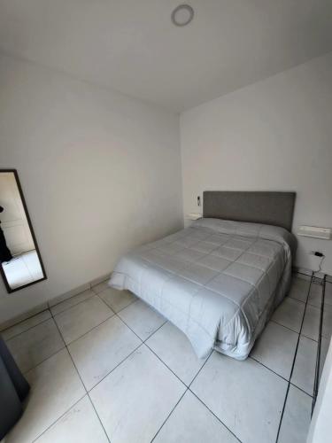 a bedroom with a bed in a white room at Depto Civora 2 in Villa Regina