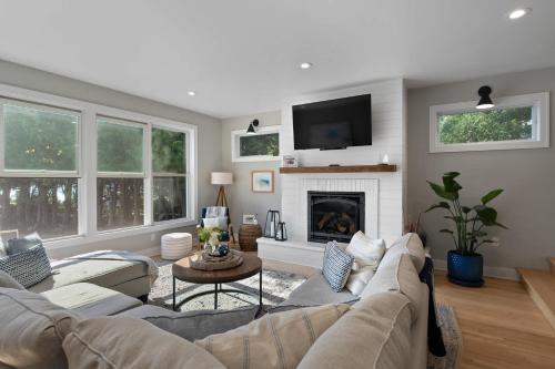 a living room with a couch and a fireplace at Limestone Edge by Simple Life Rentals in Baileys Harbor