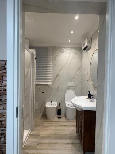 a bathroom with a sink and a toilet at Dimora Leonida in Taranto
