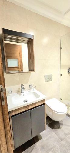 a bathroom with a sink and a toilet at Andre Luxury Apart in Laayoune