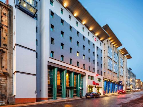 a building on a street with cars parked in front at ibis Glasgow City Centre – Sauchiehall St in Glasgow
