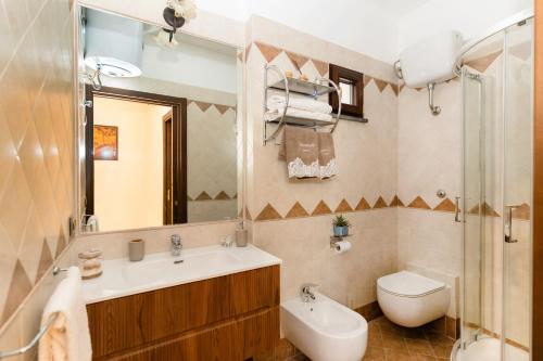 a bathroom with a sink and a toilet and a mirror at GrandPa's House in Sorrento