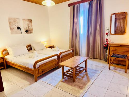 a bedroom with a bed and a table in a room at Gradakia Cottages 1 in Argostoli