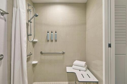 a bathroom with a shower and a toilet with towels at Courtyard Rochester Brighton in Rochester