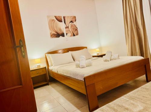 a small bedroom with a bed with white pillows at Gradakia Cottages 2 in Argostoli