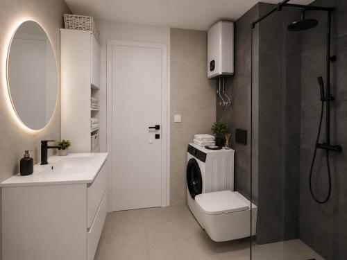 a bathroom with a toilet and a sink and a shower at Sunset Aura in Sukošan