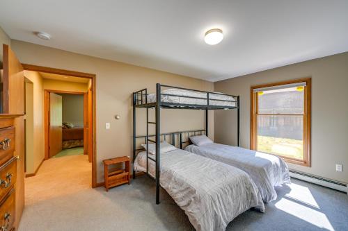 a bedroom with two bunk beds and a window at Wooded Applegate Retreat w/ Private Trail Access in Applegate