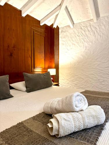 a bedroom with a bed with a towel on it at Terra Campo Posada in Chacras de Coria