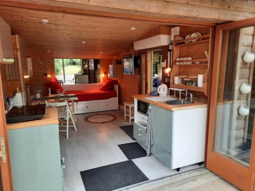 a kitchen and living room of a tiny house at Chalet dans la nature avec spa in Espins