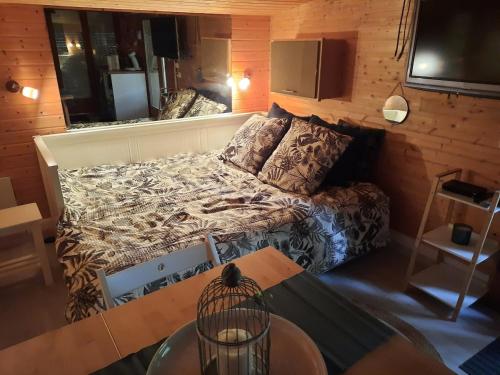 a small room with a bed and a table at Chalet dans la nature avec spa in Espins