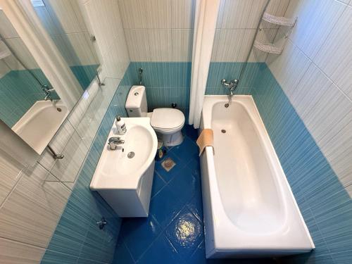 a bathroom with a tub and a toilet and a sink at Apartment Orange Blossom First Line & Pool 2 in Bijela