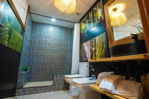 a bathroom with a toilet and a shower at epicenter LAGOA in Lagoa