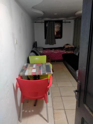 a room with a table and chairs and a living room at tbs1 in Safi
