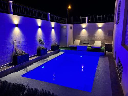a swimming pool at night with purple lights at Villa Sara, Piscine et Jardin privée in Marrakesh