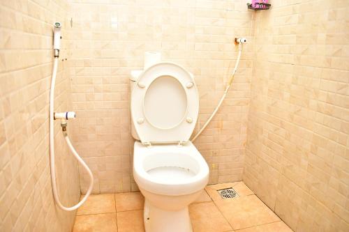 a bathroom with a white toilet with a shower at Oceanic Homes in Mombasa