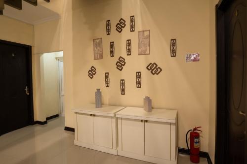 a room with two white cabinets and pictures on the wall at Chill Out Hotel Tskaltubo in Tsqaltubo