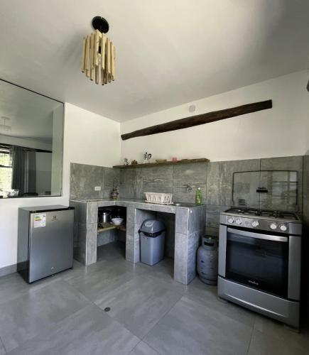 a large kitchen with a stove and a sink at Aldealma in Pisac