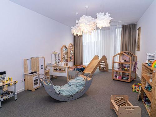 a room with a playroom with a bed and furniture at Novotel Kraków City West in Krakow