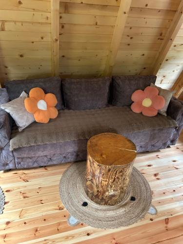 a living room with a couch with flowers on it at Komarnica Forest Owl 1 in Šavnik