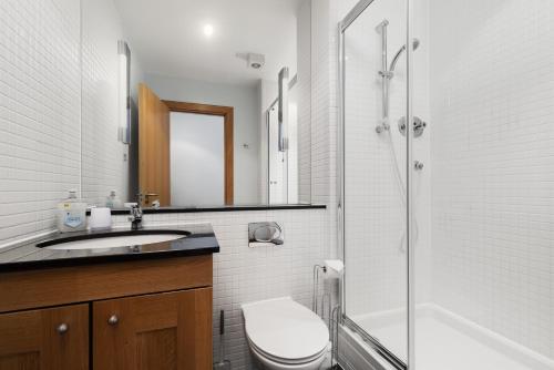 a bathroom with a toilet and a sink and a shower at No18 The Links Apartment, Brora in Brora