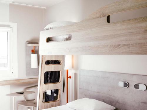 a bedroom with a bunk bed with a ladder at ibis Budget Luxembourg Aeroport in Luxembourg