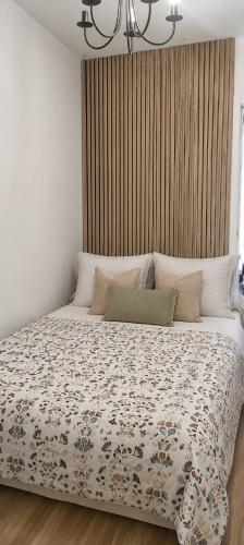 a bedroom with a bed with a comforter on it at Badalona Old Town Dalt de la Vila in Badalona