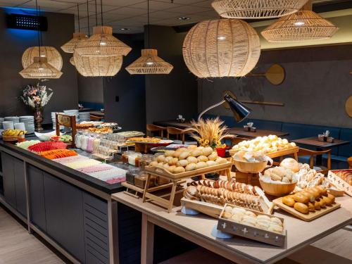 a buffet line with many different types of food at Ibis Florianopolis in Florianópolis