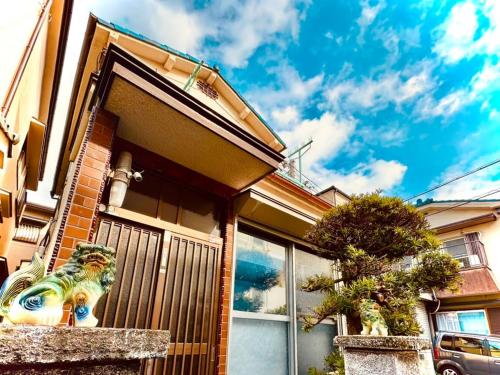 a house with a gate on the side of it at Between Kyoto & Osaka 渚西 駅徒歩6分 in Hirakata