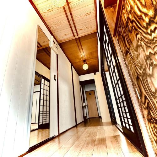 an empty hallway of a building with a wooden ceiling at Between Kyoto & Osaka 渚西 駅徒歩6分 in Hirakata