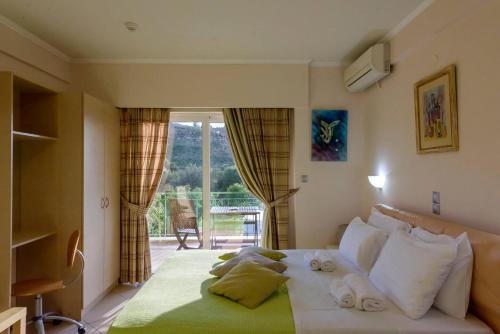 a bedroom with a large bed with towels on it at Ktima Anastasia Olive Grove Nafplio in Nafplio