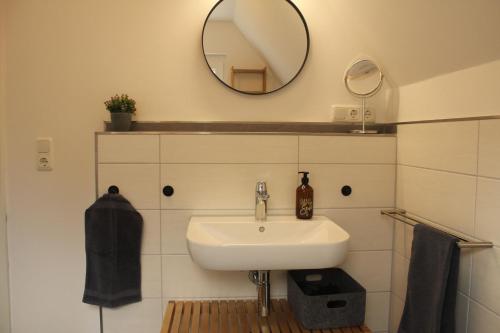 a bathroom with a sink and a mirror at Ferienwohnung "Groote Koje" in Barßel
