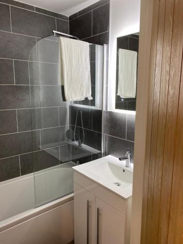 a bathroom with a sink and a shower at Have a fun and rest in Hull