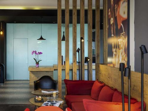 a living room with a red couch and a fireplace at Ibis Istanbul Zeytinburnu in Istanbul