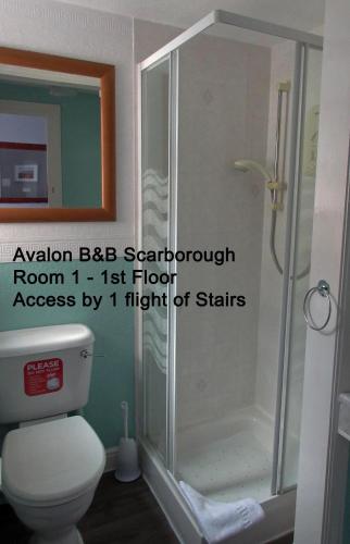 a bathroom with a shower and a toilet at Avalon B&B Scarborough in Scarborough