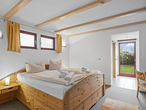 a bedroom with a wooden bed in a room at Seestrasse 35 in Insel Poel
