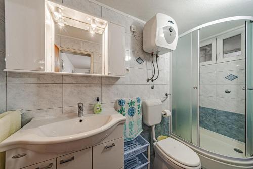 a bathroom with a sink and a toilet and a shower at Apartments by the sea Grscica, Korcula - 169 in Prizba