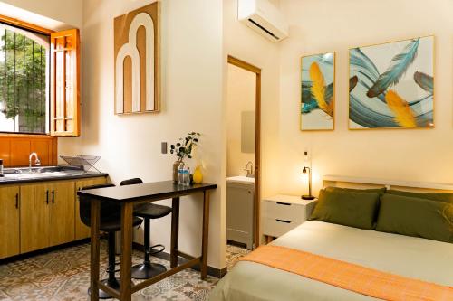a bedroom with a bed and a desk and a sink at Casa del Patio in Guadalajara