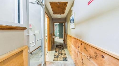 a hallway with a door and a tile floor at Sleeping Bear by AvantStay in North Creek
