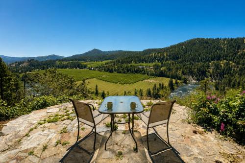 a table and two chairs sitting on top of a rock at River Heights Home cabin in Leavenworth