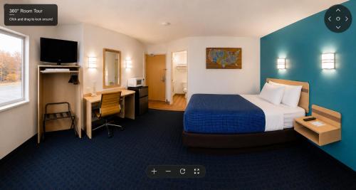 a hotel room with a bed and a desk at Econo Lodge Menomonie in Menomonie