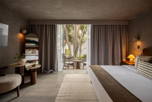 a hotel room with a bed and a large window at Casa Levora in Mexico City