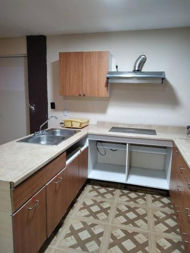a kitchen with a sink and a counter top at Casa Corazon Centro in Oaxaca City