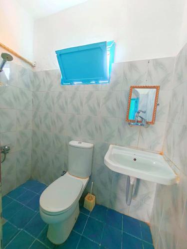 a bathroom with a white toilet and a sink at blue Bird in Nuweiba‘ el Muzeinah