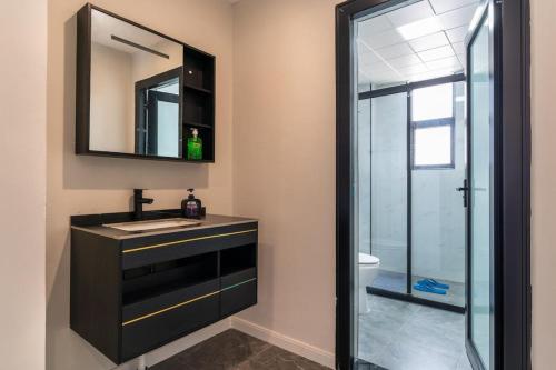 a bathroom with a sink and a mirror at Spectacular 3 bedroom apartment in Syokimau