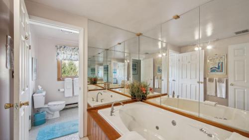 a large bathroom with a tub and a toilet at Quick Silver - Summit at Gore Mountain by AvantStay in North Creek