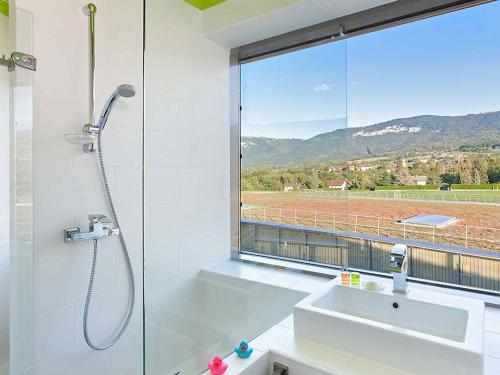a bathroom with a shower and a sink and a window at ibis Styles Saint Julien en Genevois accès espace aquatique UCPA Vitam INCLUS in Neydens