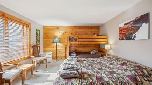 a bedroom with a bed in a room with wooden walls at Echo by AvantStay in North Creek
