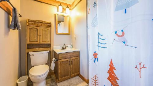 a bathroom with a toilet and a sink at Echo by AvantStay in North Creek